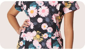 View our selection of White Cross print scrub tops