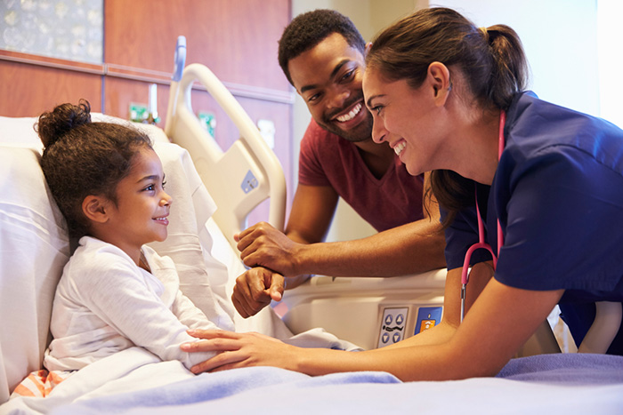 pediatric nurse visiting child and father in hospital