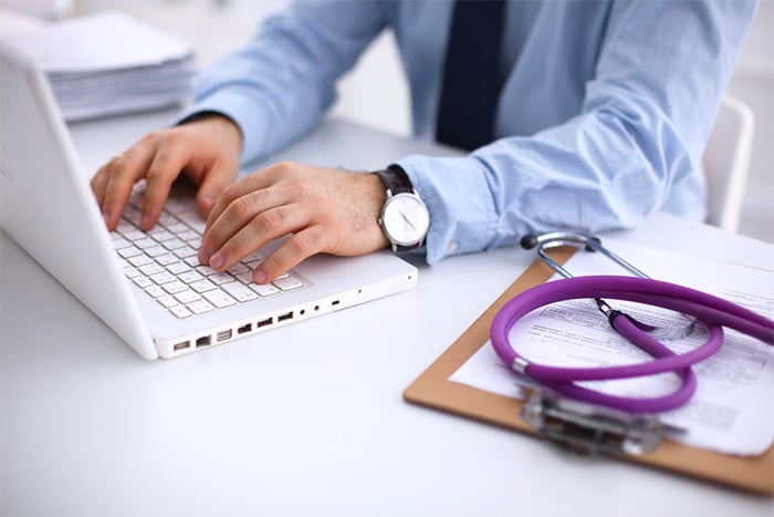 doctor using laptop for nurse recruitment