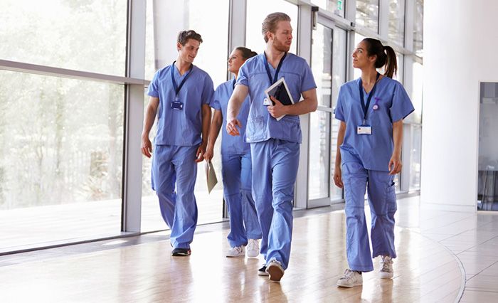 group of nurses walking down corridor