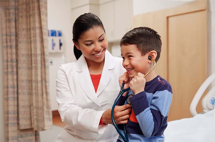 pediatrician smiling with young patient
