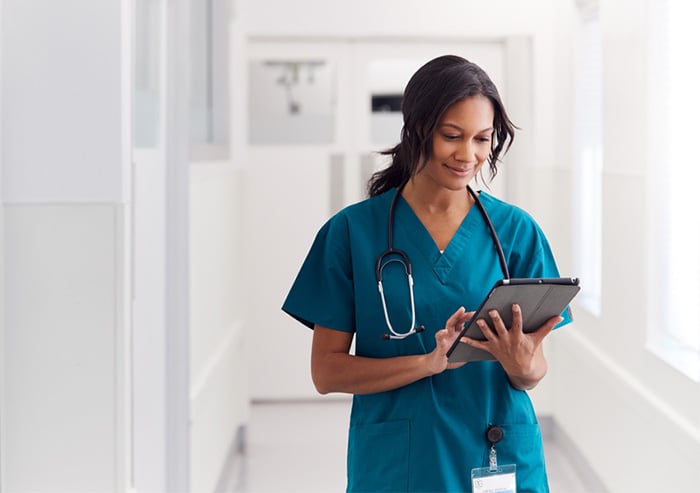 female nurse wearing blue scrubs at hospital