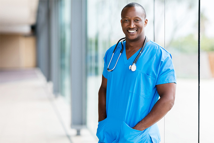 smiling male surgeon wearing scrubs 