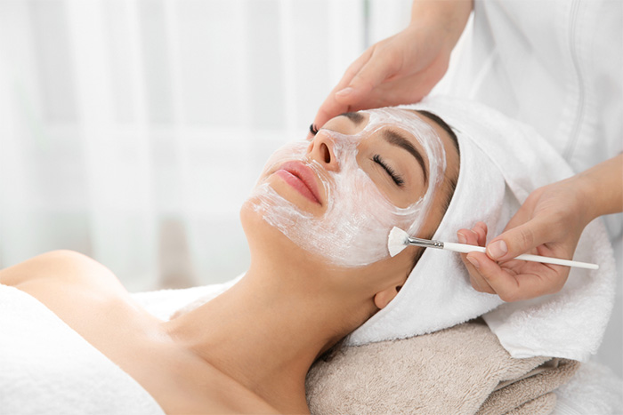 dermatologist applying mask to patient