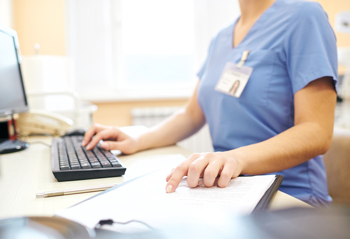 nursing informatics professional checking notes