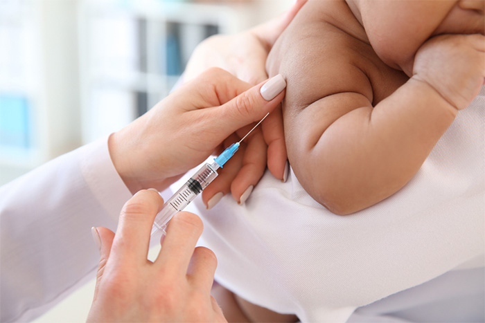 pediatrician giving baby a vaccination