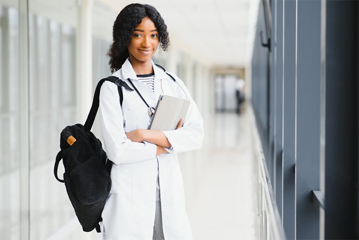 smiling young pediatrician in white lab coat