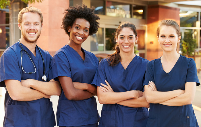 group of registered nurses smiling outsiden