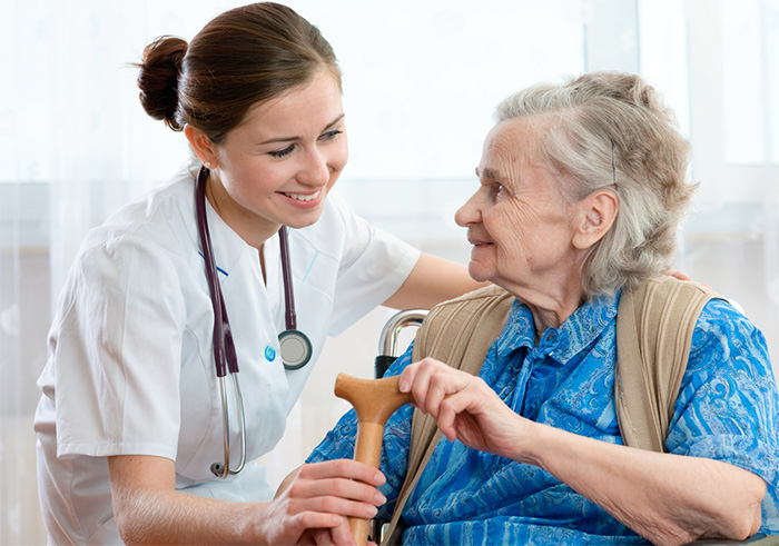 caregiver taking care of elderly patient