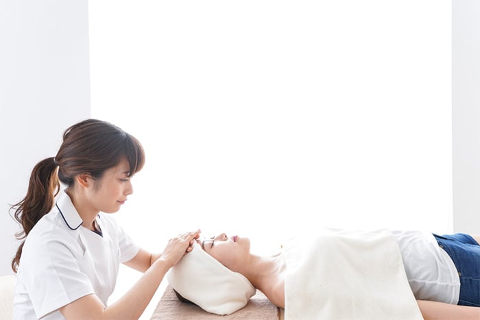 esthetician working with client at beauty salon