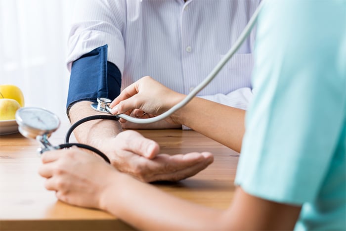 medical assistant taking blood pressure