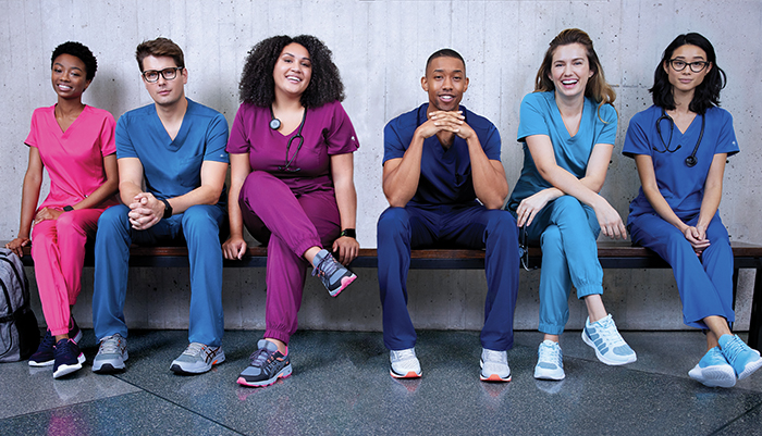 smiling healthcare workers wearing scrubs