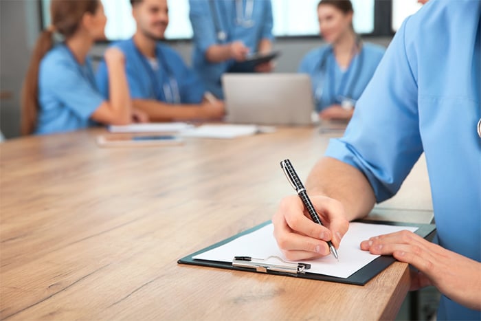 dermatologist writing on clipboard