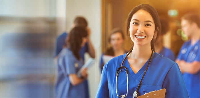smiling medical student with clipboard and stethoscope