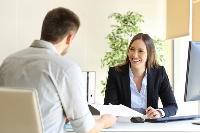 Interviewer smiling at interviewee during an interview