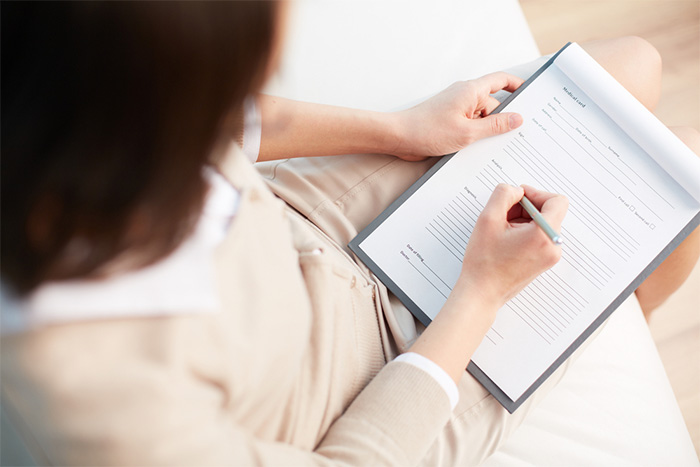 woman writing down information