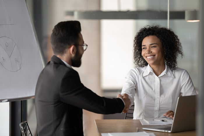 male and female shaking hands before a nursing interview