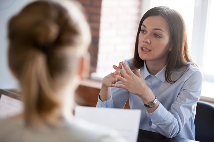 professional woman talking during a nursing interview