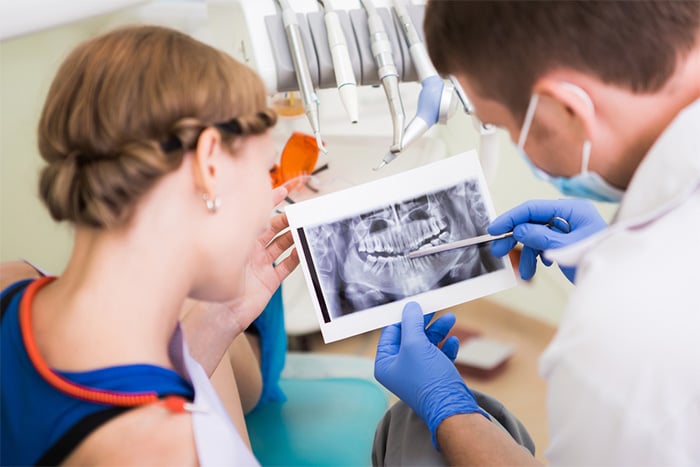 dentist going over x-ray with patient